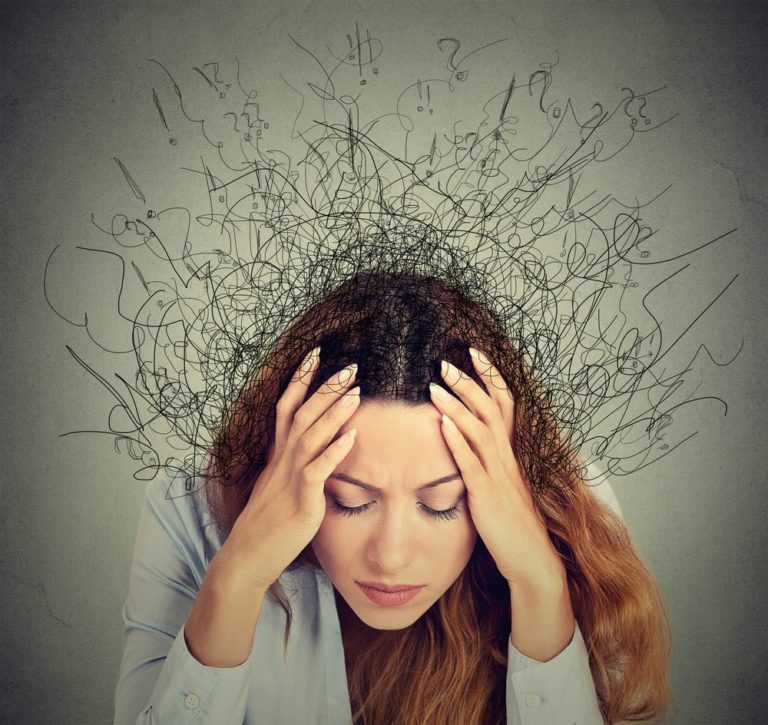 Closeup sad young woman with worried stressed face expression and brain melting into lines question marks suffering from anxiety disorder